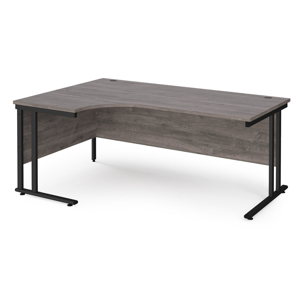 Corner office desk with wooden surface and black metal legs on a white background
