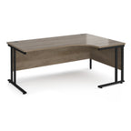 Corner office desk with wooden surface and black metal legs on a white background