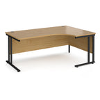 Wooden corner desk with black metal legs on a white background