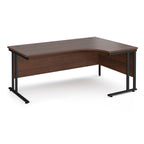 Wooden corner desk with black metal legs on a white background