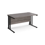Office desk with grey wood-effect top and black metal legs on a white background