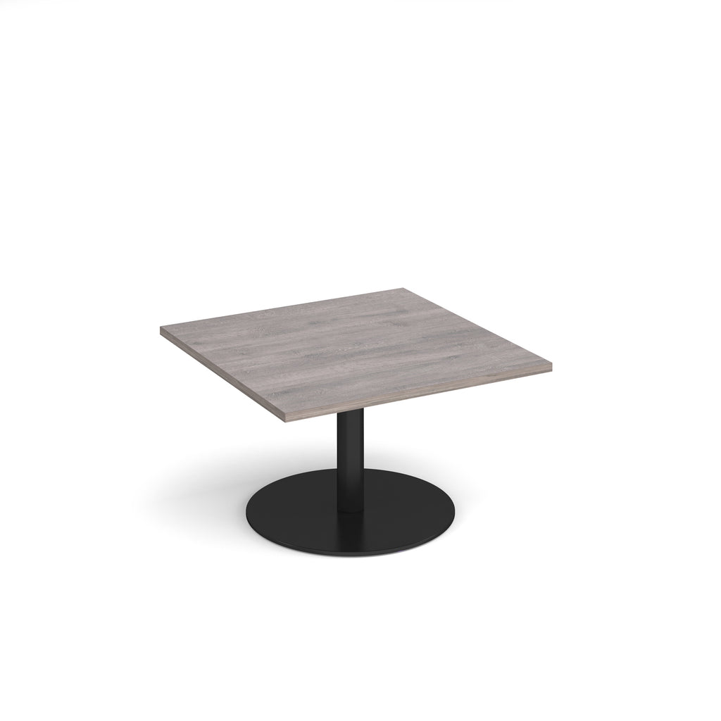 Square coffee table with a grey wood-effect top and black round base on a white background
