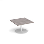 Square coffee table with grey wood-effect top and white round base on a white background