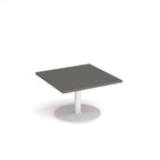 Square coffee table with grey top and white round base on a white background