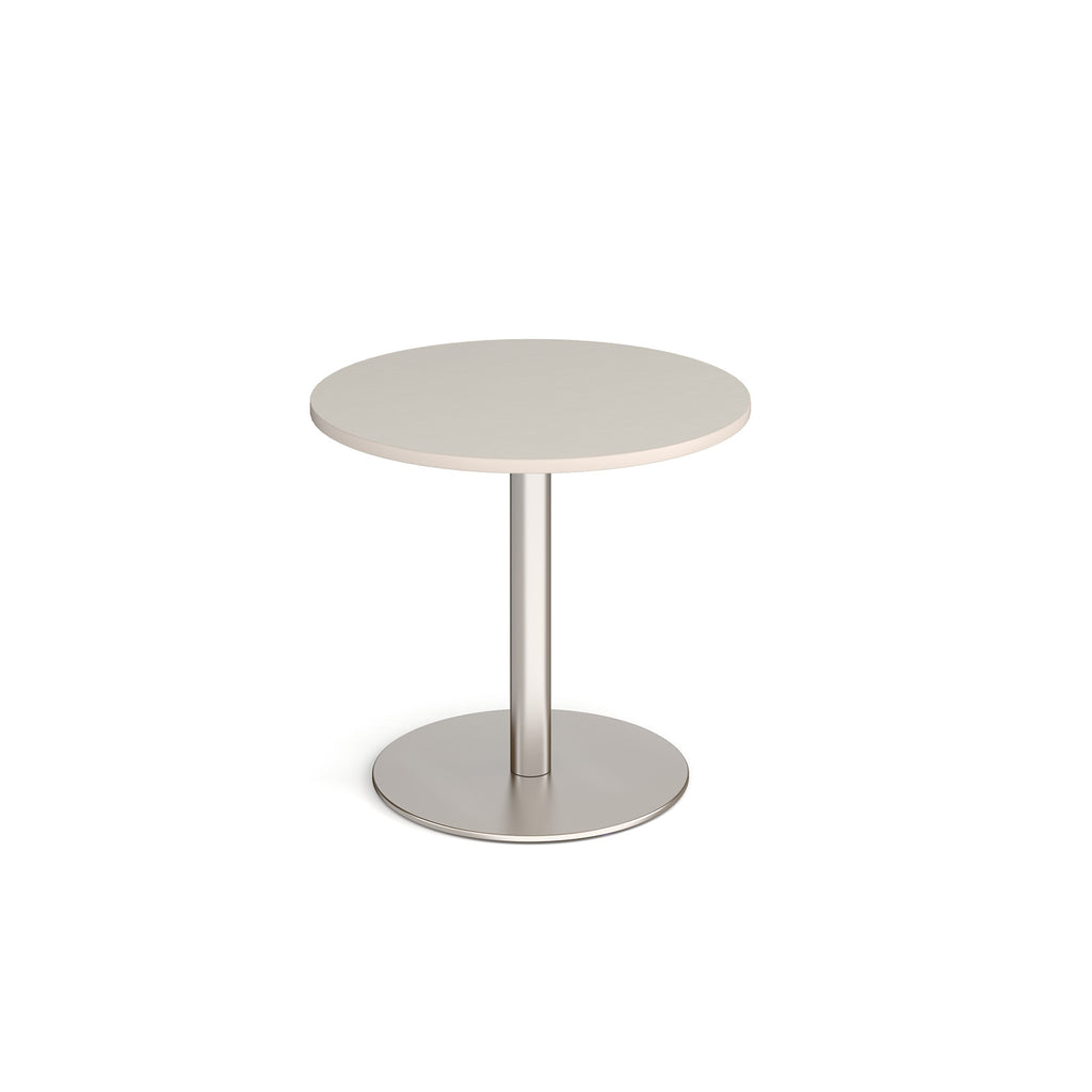 Round table with light grey top and metal base on a white background