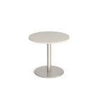 Round table with light grey top and metal base on a white background