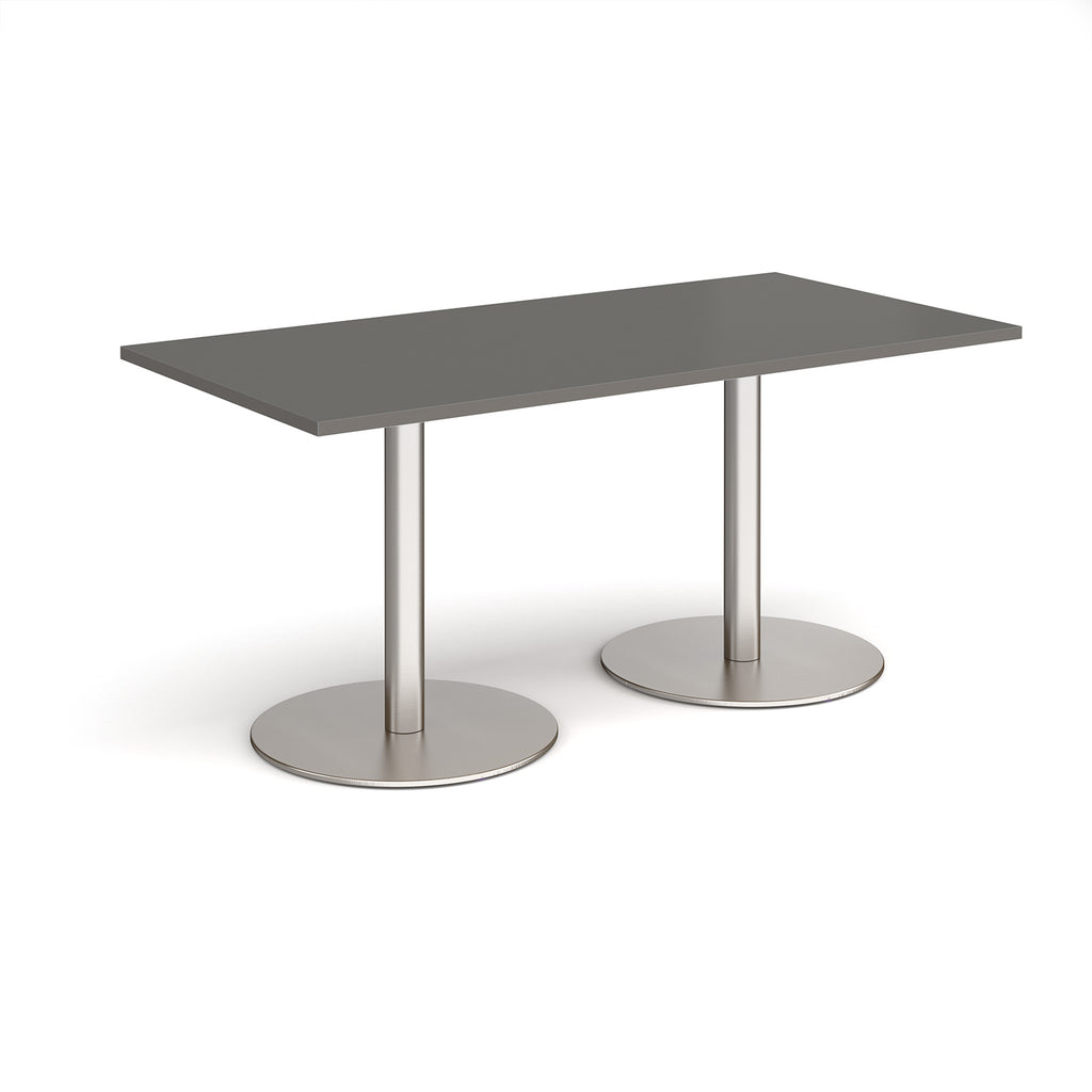 Rectangular table with grey top and metal legs on a white background