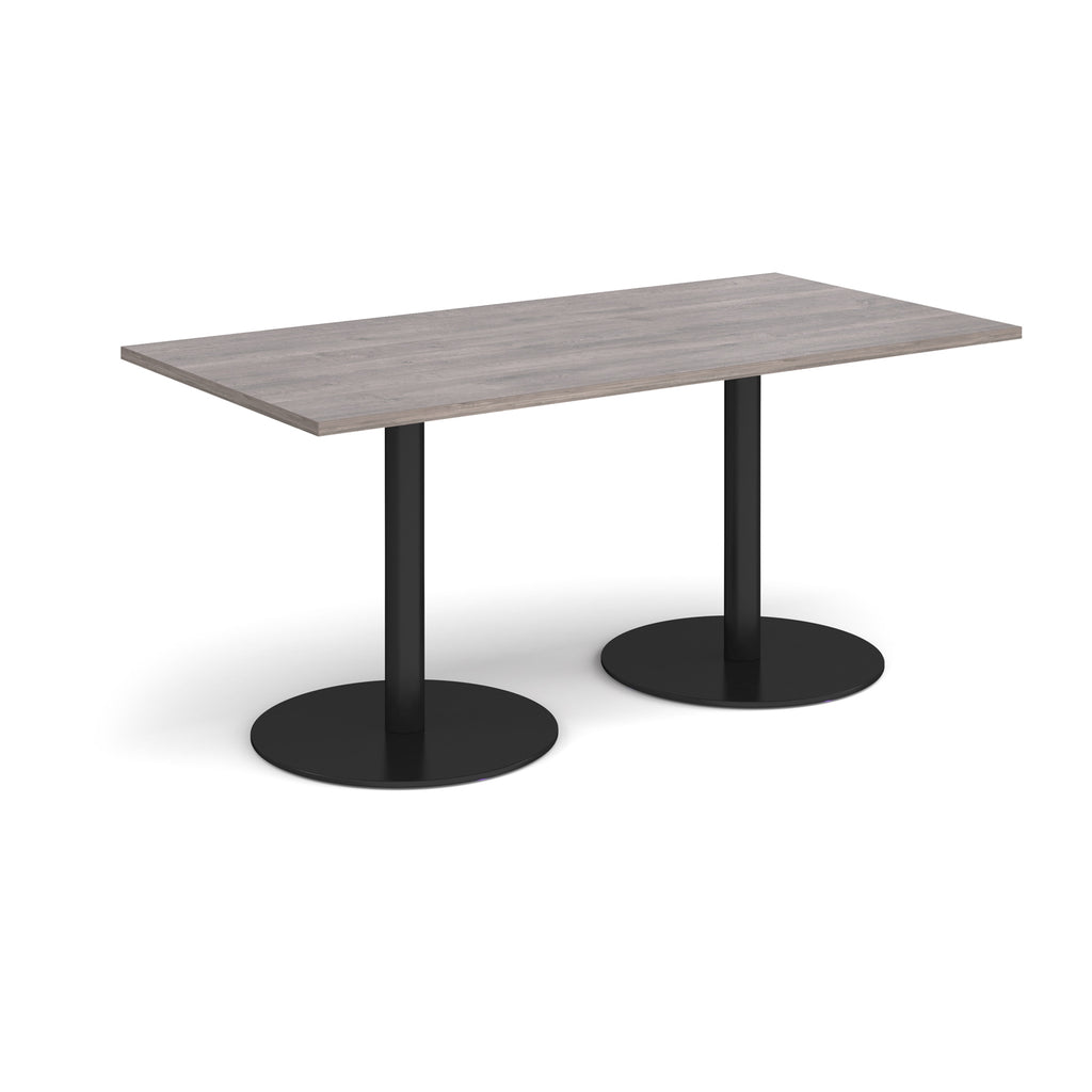 Rectangular table with a grey top and black legs on a white background