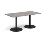 Rectangular table with a grey top and black legs on a white background