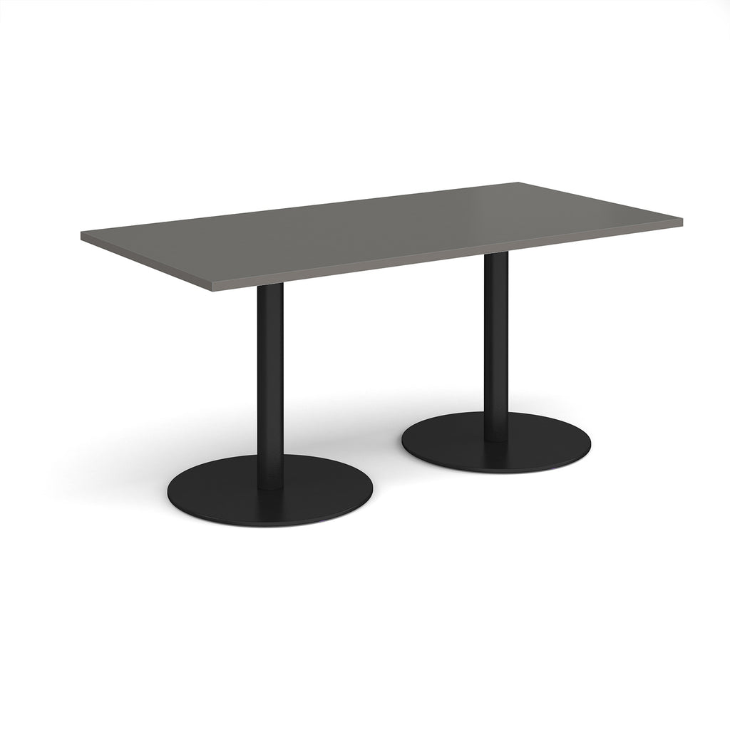 Rectangular table with dark grey top and black legs on a white background