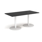 Rectangular black table with white cylindrical bases on a white background