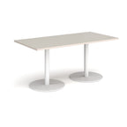 Rectangular light grey table with white legs on a white background