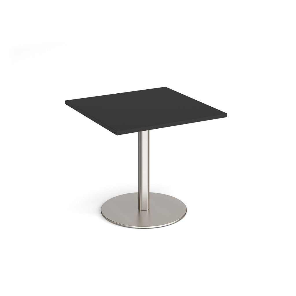Square table with black top and metal base on a white background