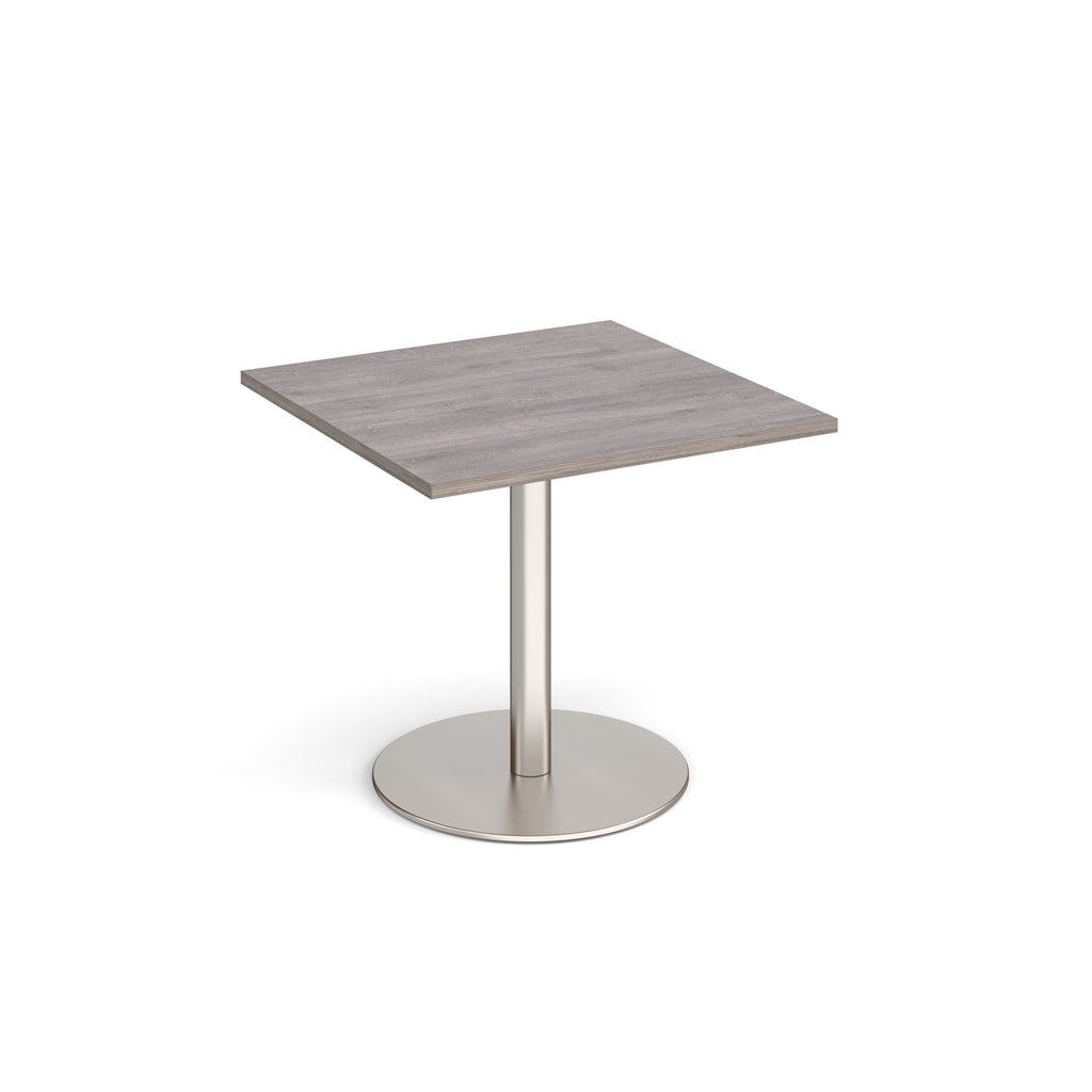 Square table with wood-effect top and metal base on a white background