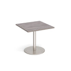 Square table with wood-effect top and metal base on a white background