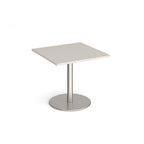 Square table with light grey top and metal base on a white background