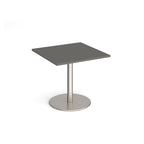 Square table with grey top and metal base on a white background