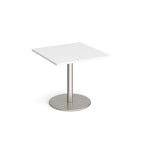 Square table with white top and metal base on a white background