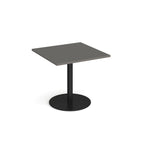 Square table with grey top and metal base on a white background