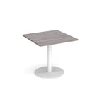 Square table with grey wood-effect top and metal base on a white background