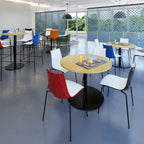 Modern cafe interior with colorful chairs and round tables.