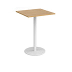Square table with a wood-effect top and white cylindrical base on a white background