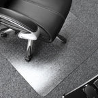 Black office chair with a transparent desk mat on a grey floor