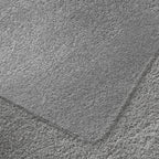 Close-up of a grey carpet and chair mat.