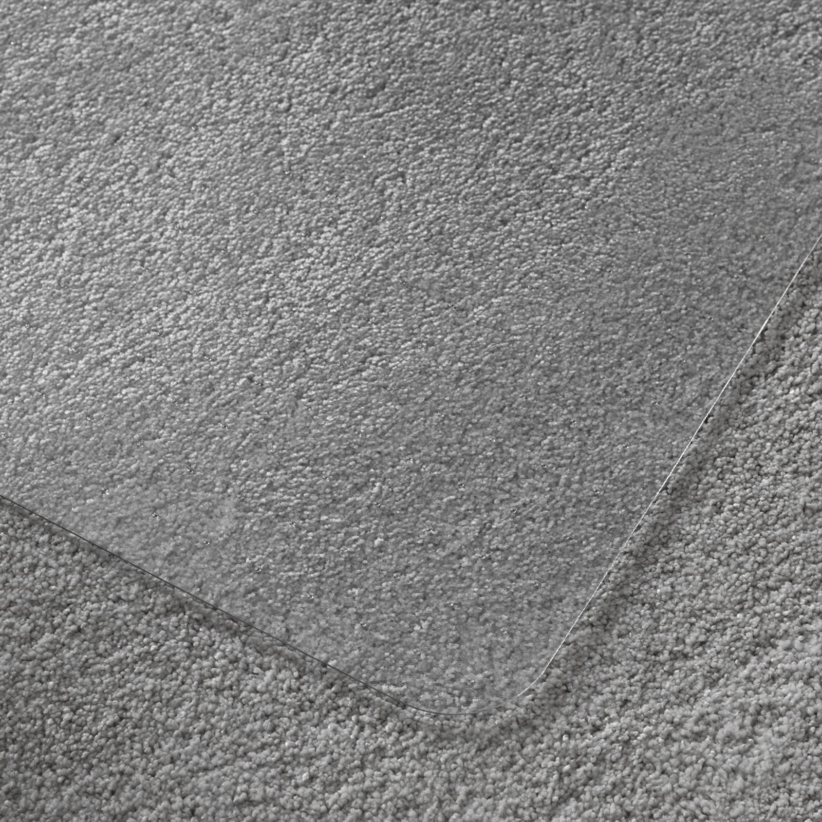 Close-up of a textured grey carpet and chair mat.