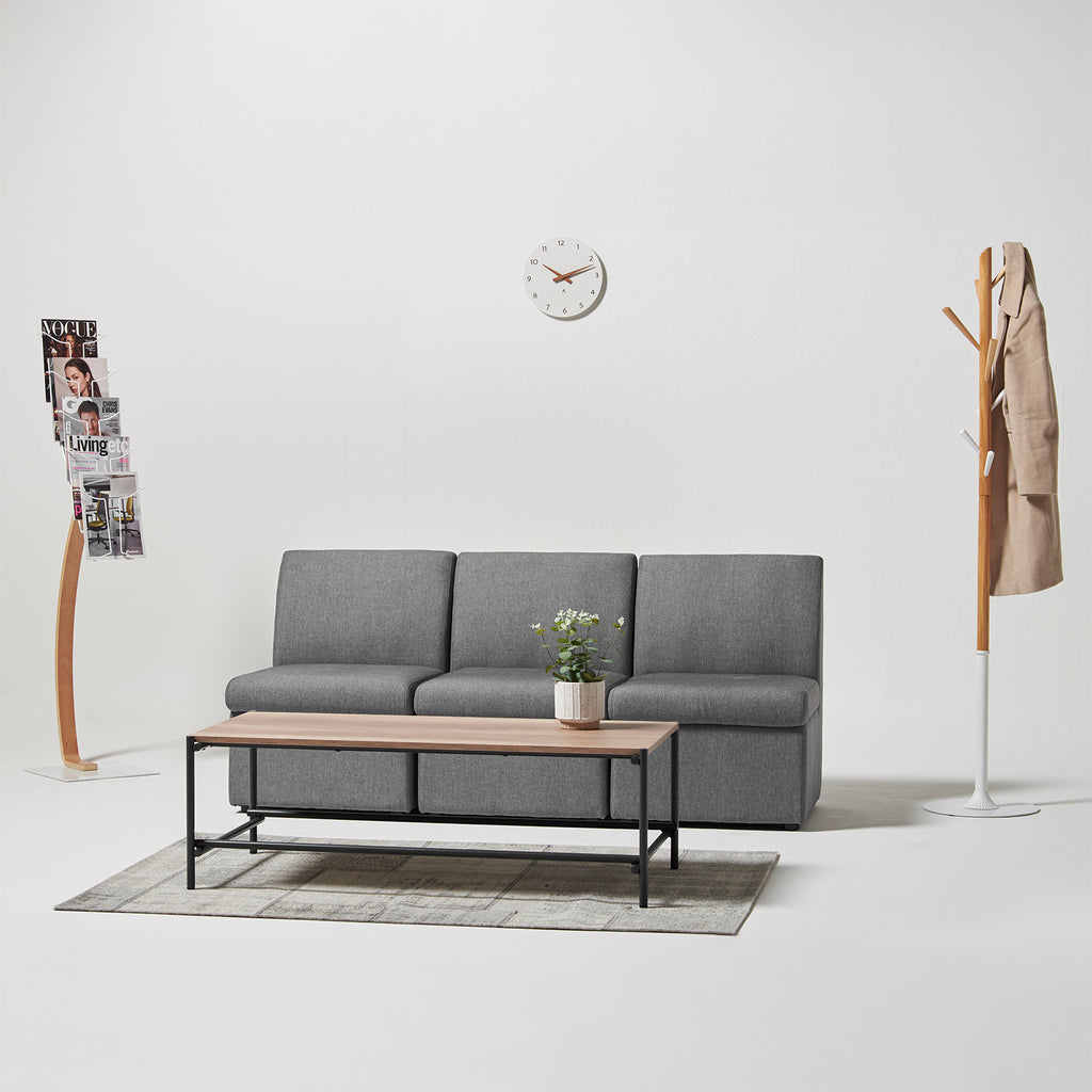 Gray sofa with wooden coffee table in a minimalistic living room setting.