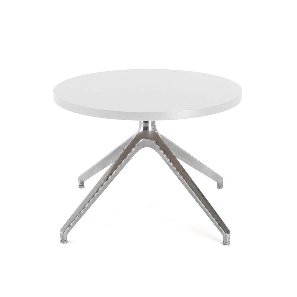 Round white table with metallic legs on a white background