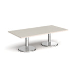 Rectangular coffee table with light grey top and chrome base on a white background