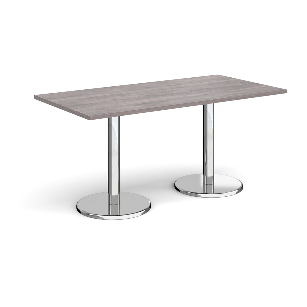 Rectangular table with grey wood-effect top and chrome legs on a white background