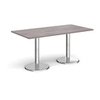 Rectangular table with grey wood-effect top and chrome legs on a white background