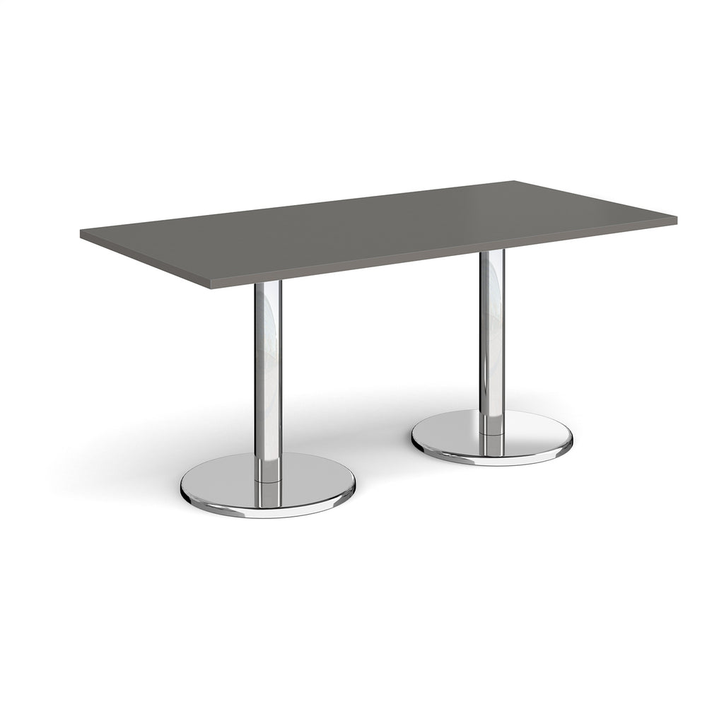 Rectangular table with grey top and chrome legs on a white background