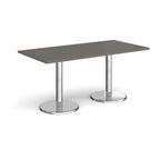 Rectangular table with grey top and chrome legs on a white background