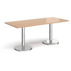 Rectangular table with wood-effect top and chrome legs on a white background