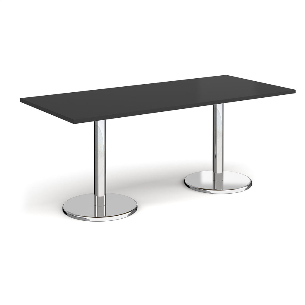 Rectangular table with black top and chrome legs on a white background