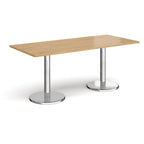 Rectangular table with wood-effect top and chrome legs on a white background