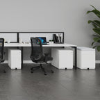 Modern office desk setup with chairs and a computer in a minimalistic office setting.