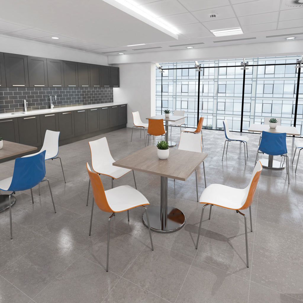 Modern office break room with tables and chairs.