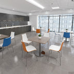 Modern office break room with tables and chairs.