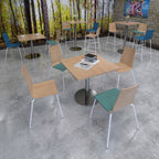 Modern cafe interior with tables and chairs against a forest mural.