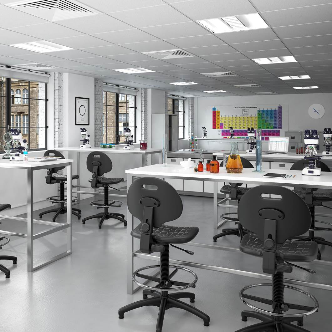 Adjustable draughtsman chairs with black contoured seats and chrome foot rings, arranged around white laboratory work benches in a modern teaching lab environment.