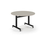 Round table with light grey top and metal legs with wheels on a white background