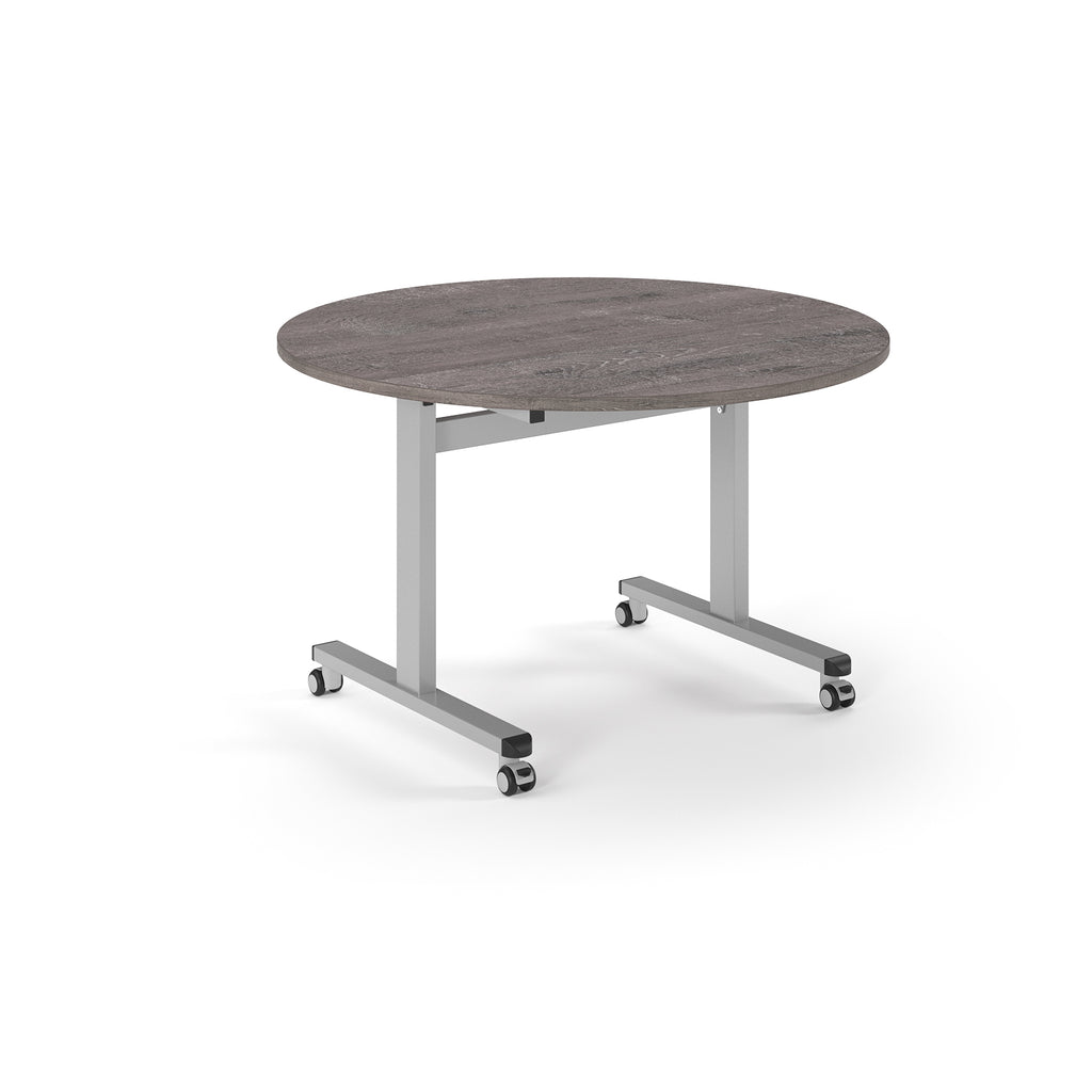 Round table with grey wood-effect top and metal legs with wheels on a white background
