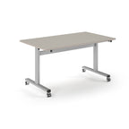 Rectangular table with light grey top and metal legs with wheels on a white background