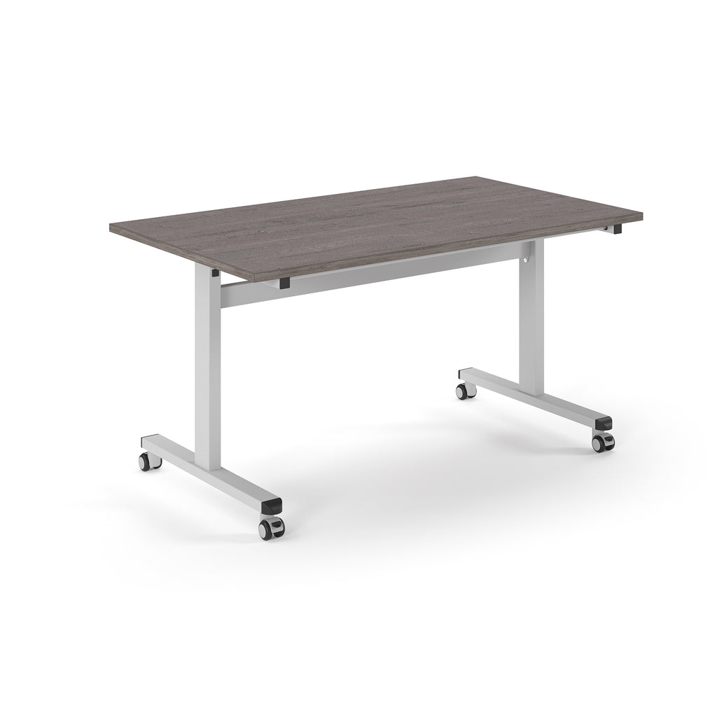 Rectangular table with grey wood-effect top and metal legs with wheels on a white background
