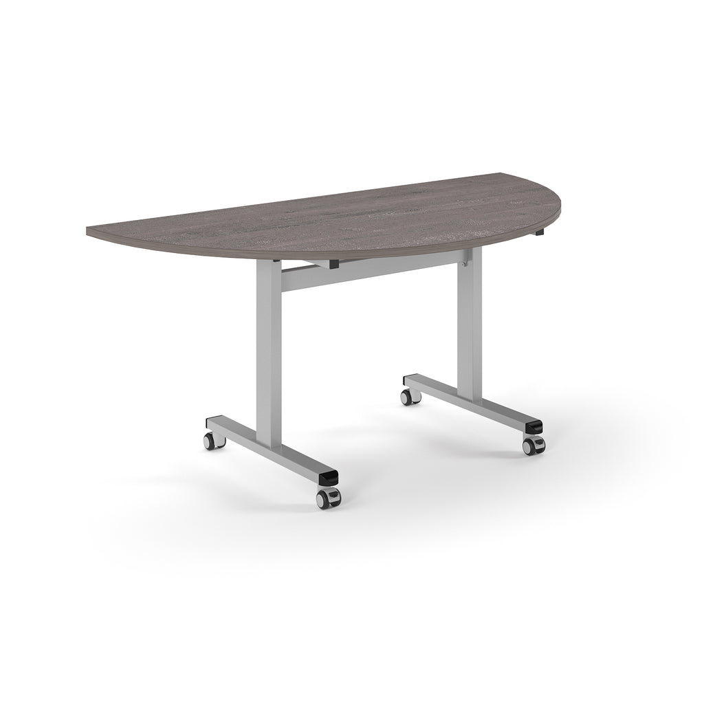 Semi-circular table with grey wood-effect top and metal legs with wheels on a white background