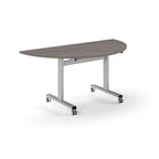 Semi-circular table with grey wood-effect top and metal legs with wheels on a white background